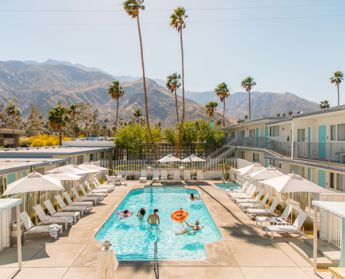 Revelers celebrate in the sparkling blue pool at the Skylark Palm Springs hotel