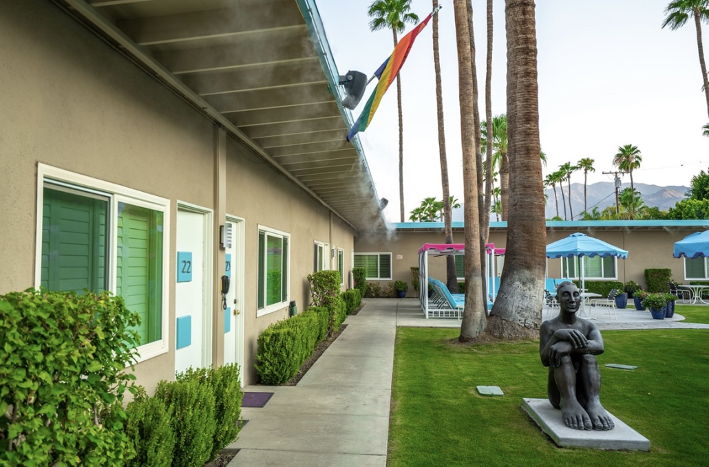 A statue of a man sitting down in the courtyard at INNdulge Palm Springs gay men's resort in Palm Springs, California