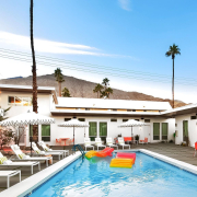 Two colorful rafts float in the courtyard pool on a sunny day at The Wesley Palm Springs hotel