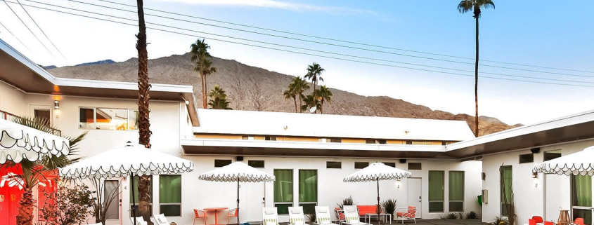 Two colorful rafts float in the courtyard pool on a sunny day at The Wesley Palm Springs hotel