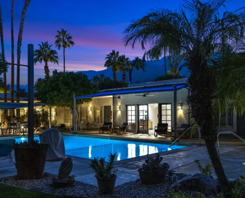 The illuminated pool at the Desert Paradise Resort for gay men in Palm Springs, California