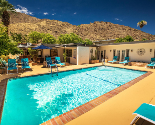 The pool surrounded by lounge chairs at Old Ranch Inn in Palm Springs, California