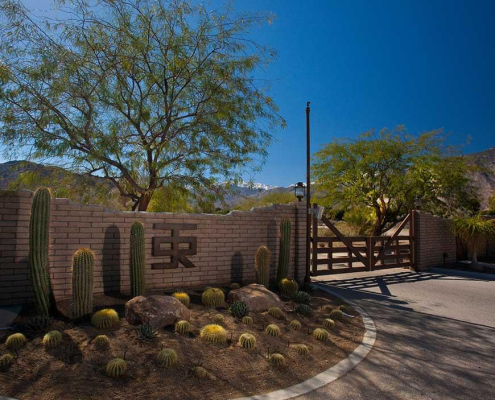 The brick entrance welcoming visitors and guests to the Smoke Tree Ranch