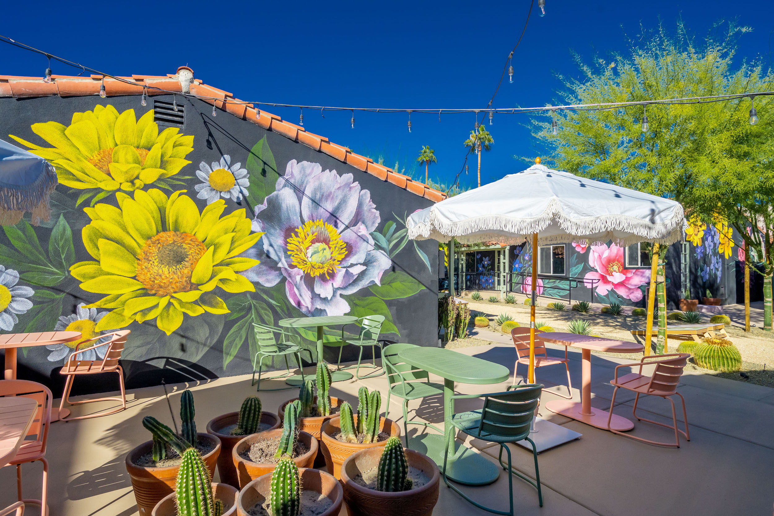 A giant mural of yellow and blue flowers at Fleur Noire Hotel in Palm Springs, California