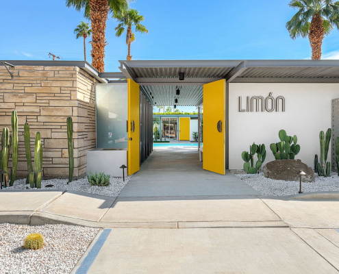 The yellow door at the front entrance to Limón Palm Springs