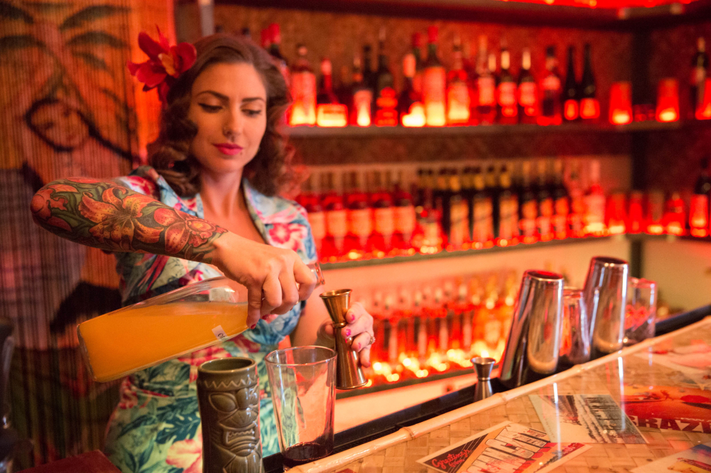 A bartender pours a drink at Bootlegger Tiki