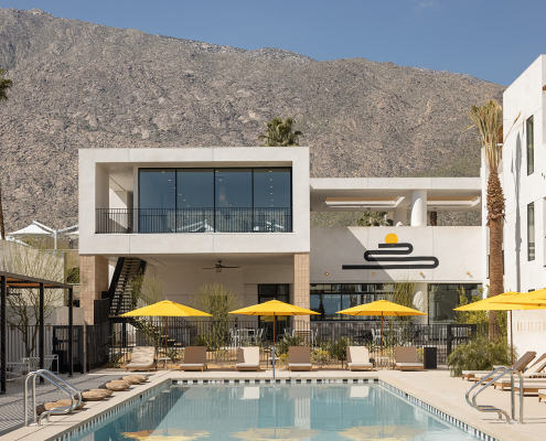 The pool surrounded by yellow umbrellas at the Drift Hotel in Palm Springs, California