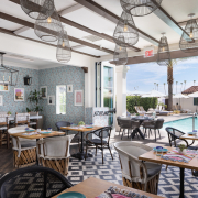 Tables and chairs in the brightly colored dining room at Azucar Restaurant at La Serena Villas