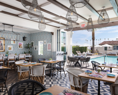 Tables and chairs in the brightly colored dining room at Azucar Restaurant at La Serena Villas