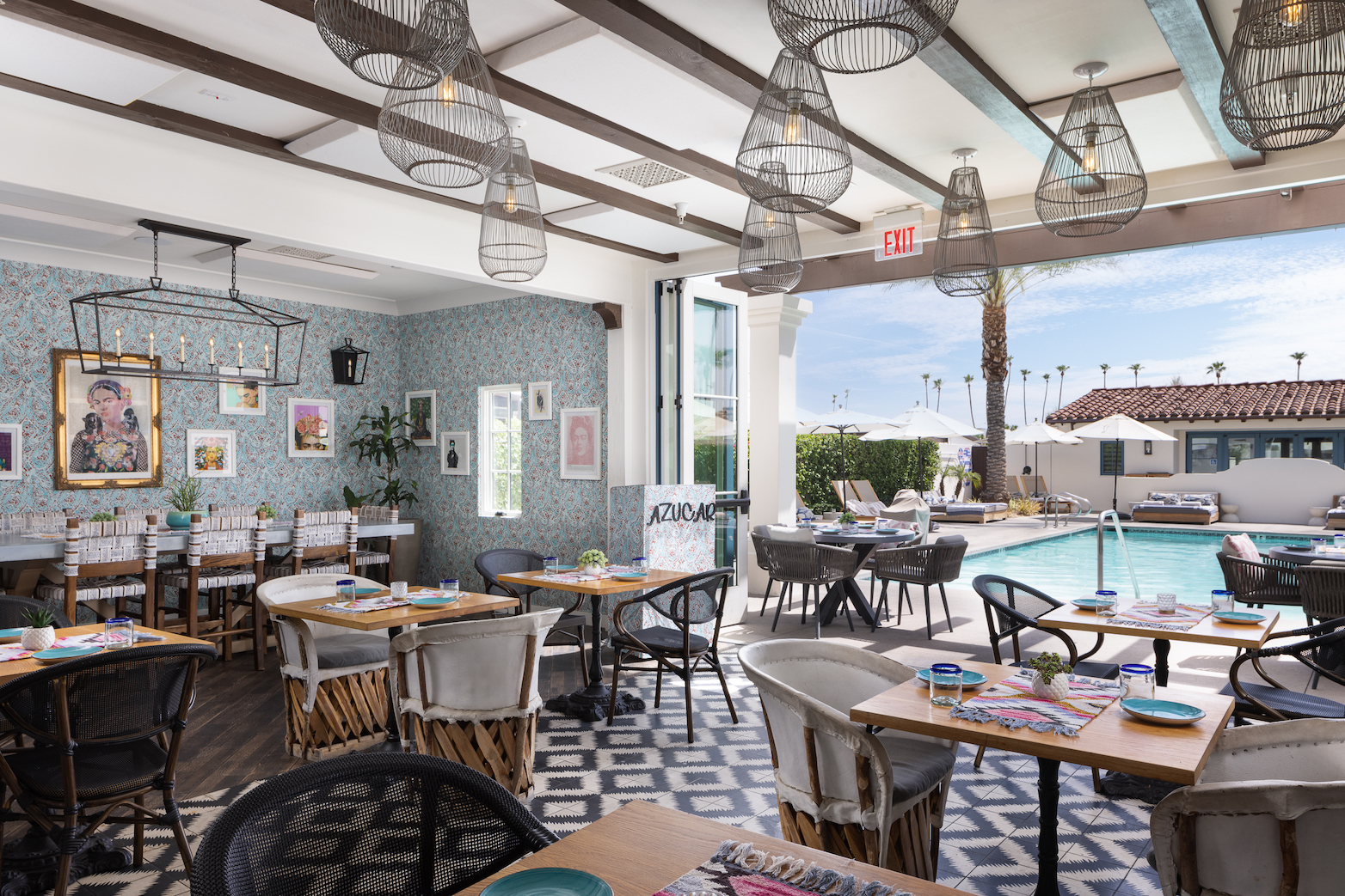 Tables and chairs in the brightly colored dining room at Azucar Restaurant at La Serena Villas