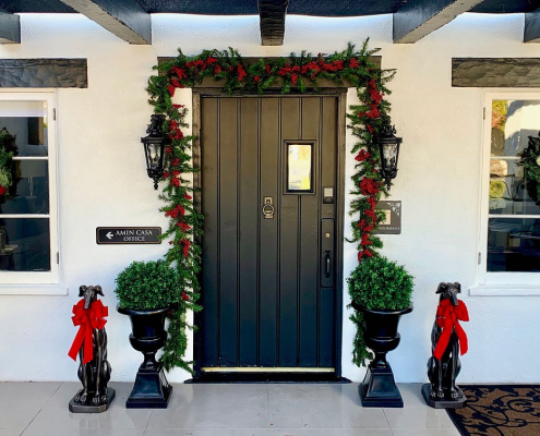 Garland and red bows are put up around the entrance of Amin Casa boutique hotel in Palm Springs, California