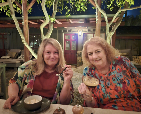 Two women with blonde hair enjoy dessert at Sparrows Lodge