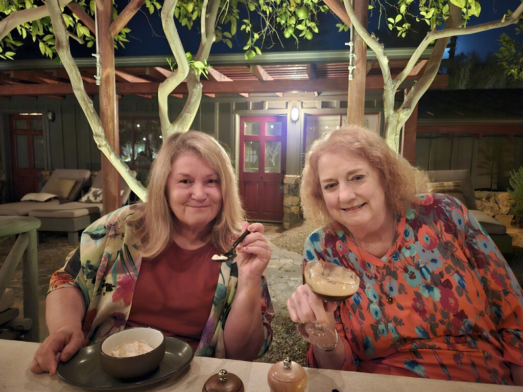 Two women with blonde hair enjoy dessert at Sparrows Lodge