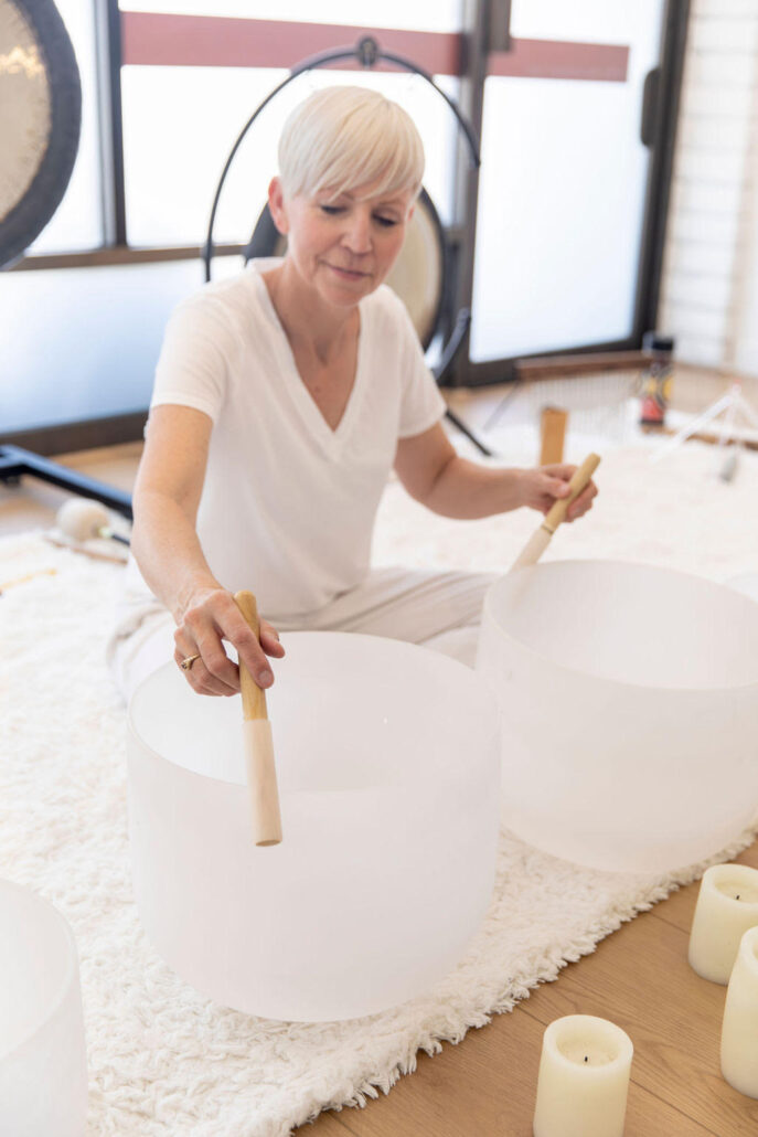 A woman leads a sound bath