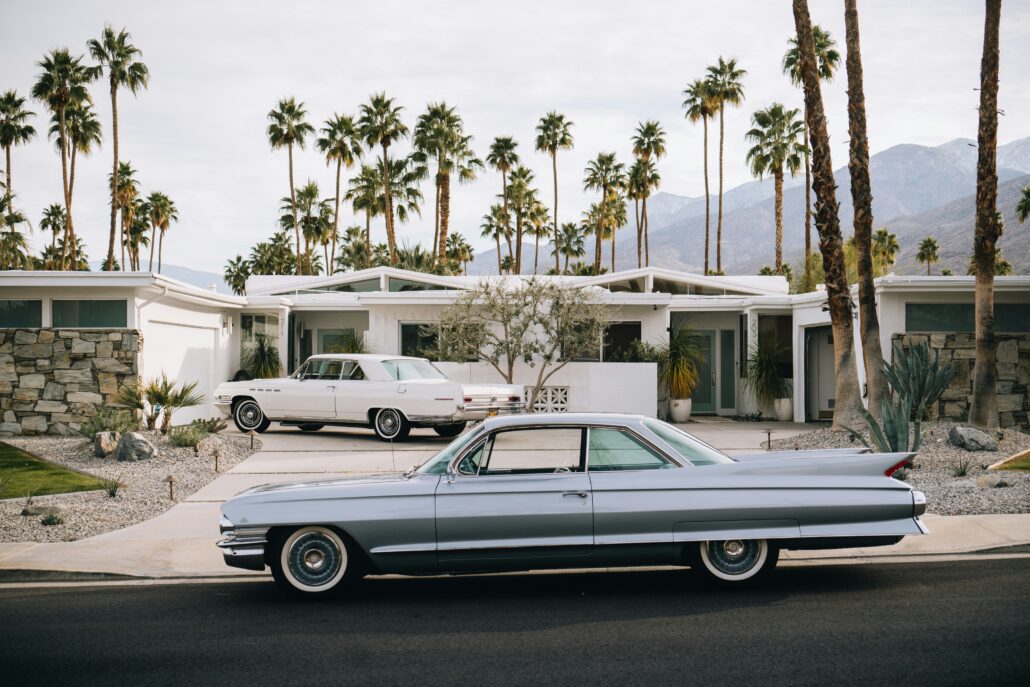 Two classic cars parked in front of a home in Palm Springs