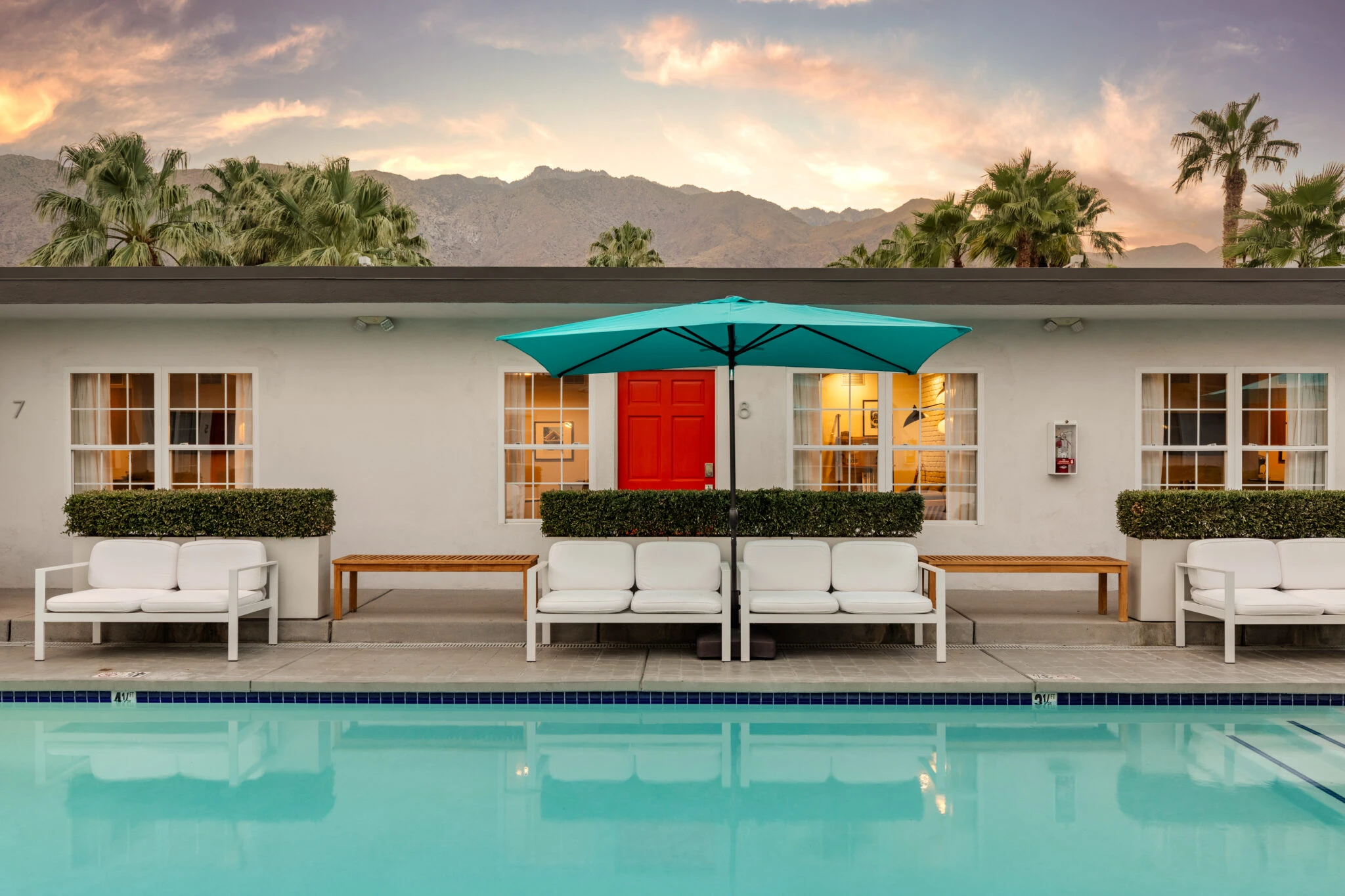 A side view of the orange doors that lead to guest rooms at The Weekend Palm Springs