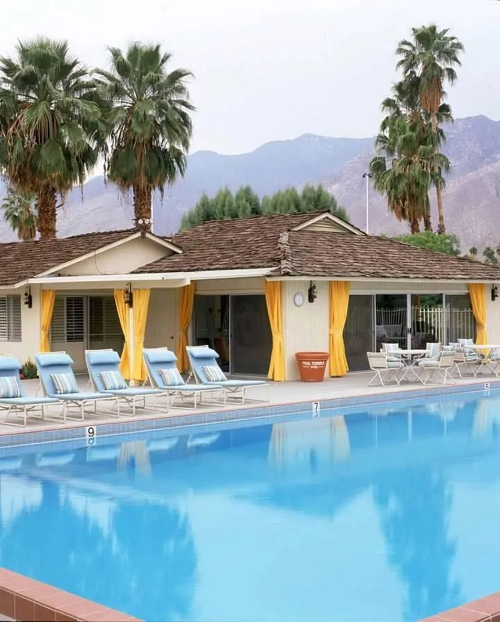 The spacious pool at Smoke Tree Ranch and the yellow clubhouse