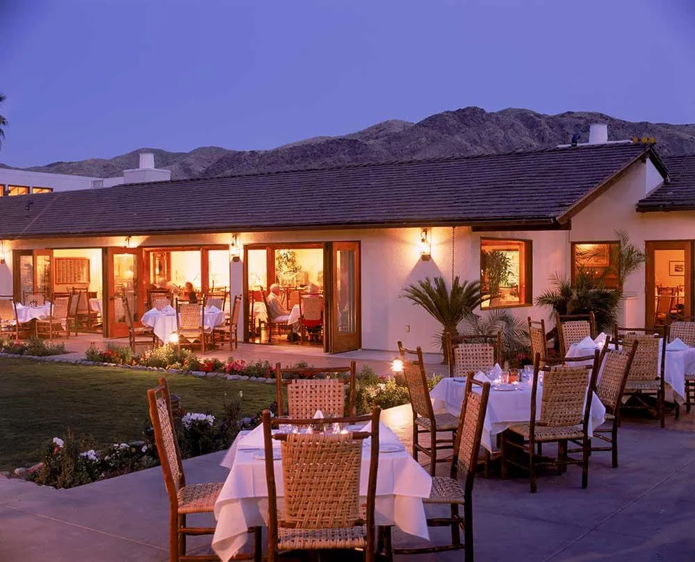 Tables set up for dinner on a patio at Smoke Tree Ranch in Palm Springs, California
