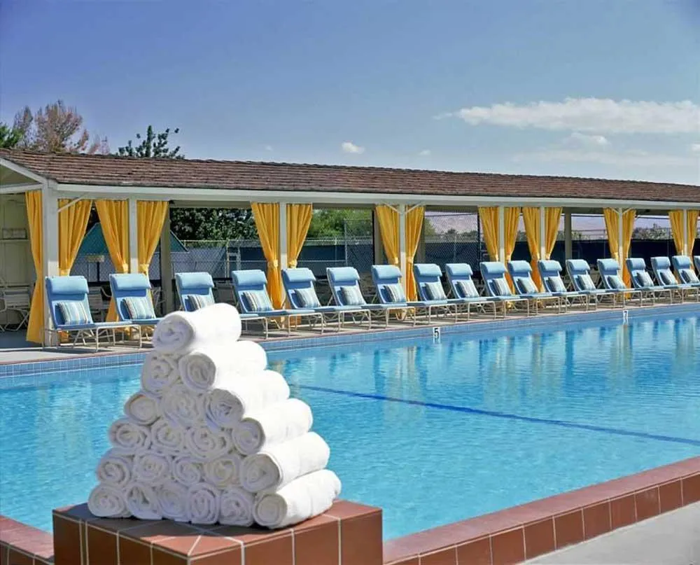 A stack of white towels for guests to use while at the Smoke Tree Ranch pool