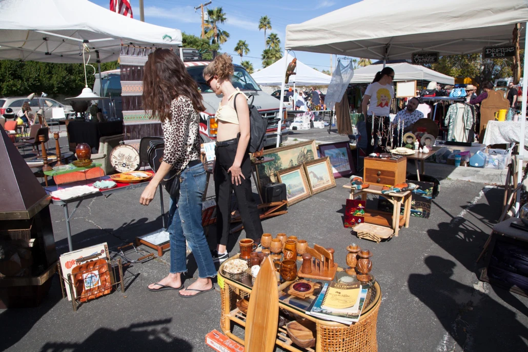 Palm Springs Vintage Market visitors peruse through retro items on a sunny day in Palm Springs