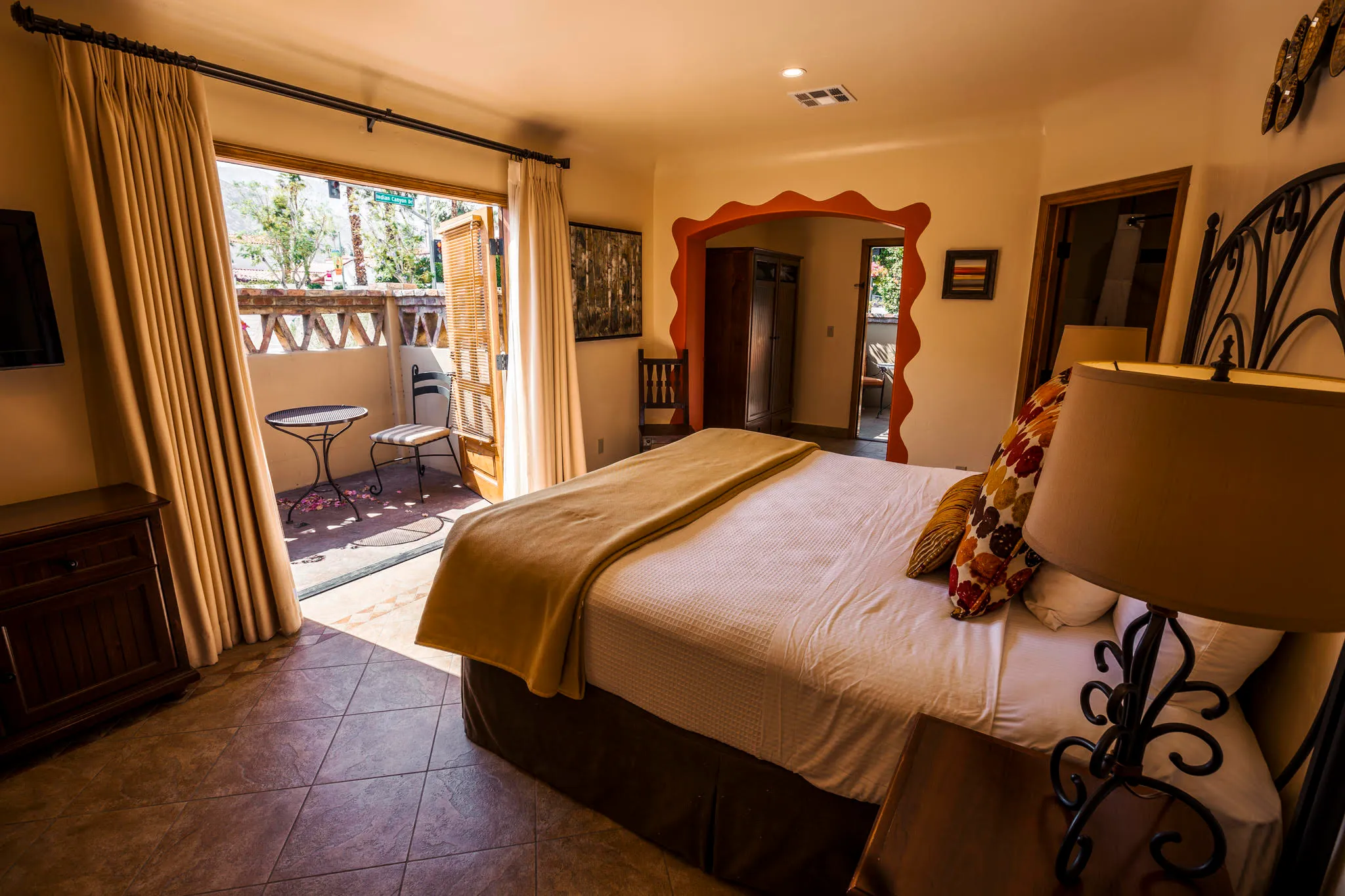 A warm and inviting room decorated in Earth tones at the Los Arboles boutique hotel in Palm Springs, California
