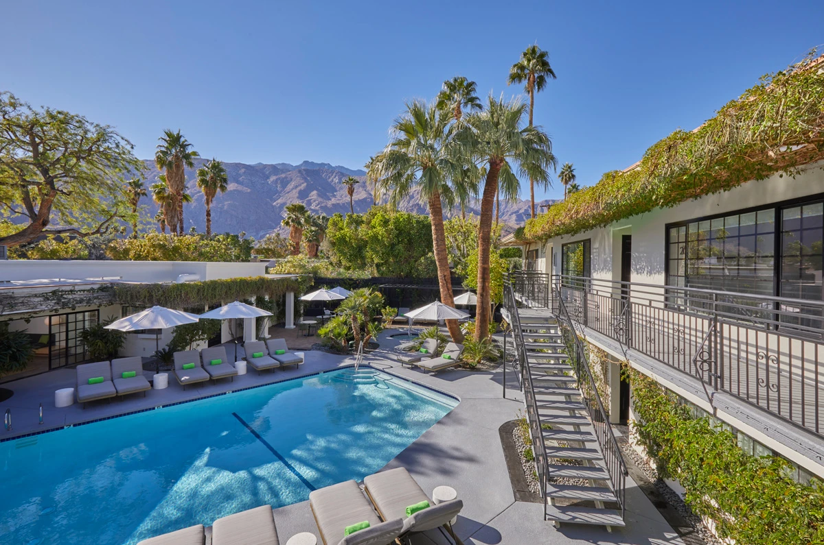 A staircase leads guests up to the second floor of comfortable poolside rooms at the Descanso Resort in Palm Springs, California
