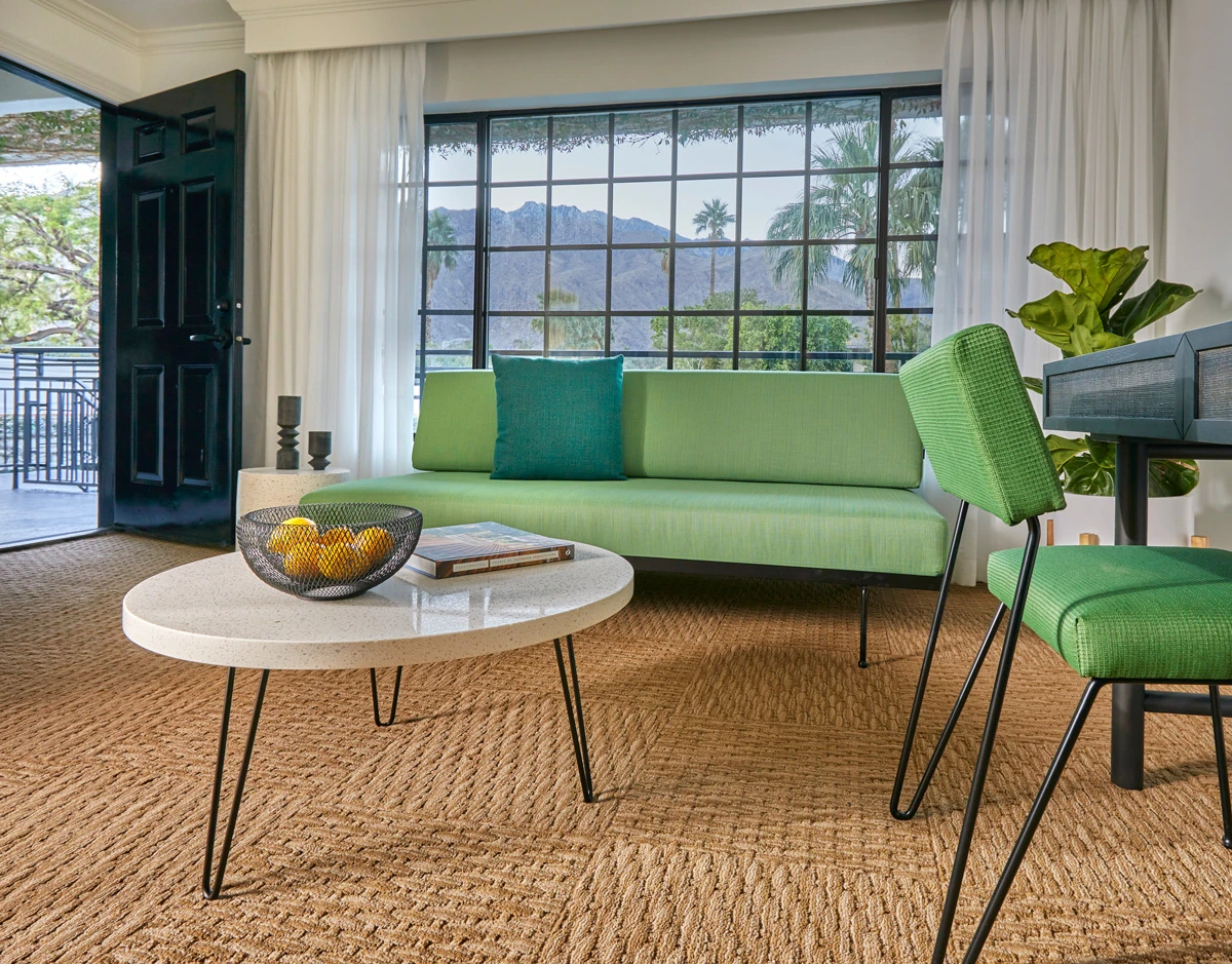 A light green couch and white table are part of the decor in this comfortable living room at Descanso Resort in Palm Springs