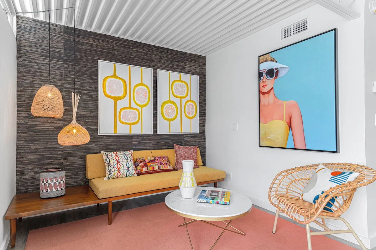 Modern art on the walls next to a retro couch at Limón Palm Springs