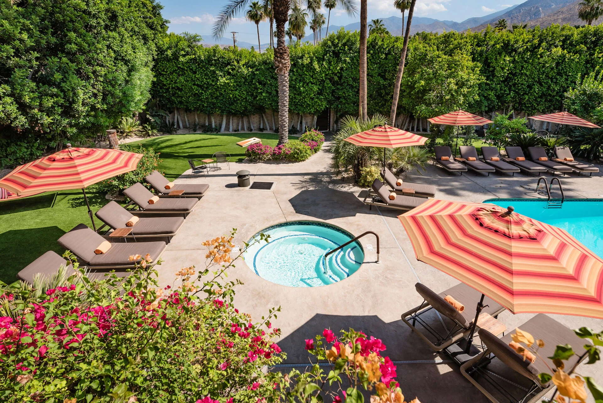 A view from above of the Santiago Resort's spa and orange and red striped umbrellas