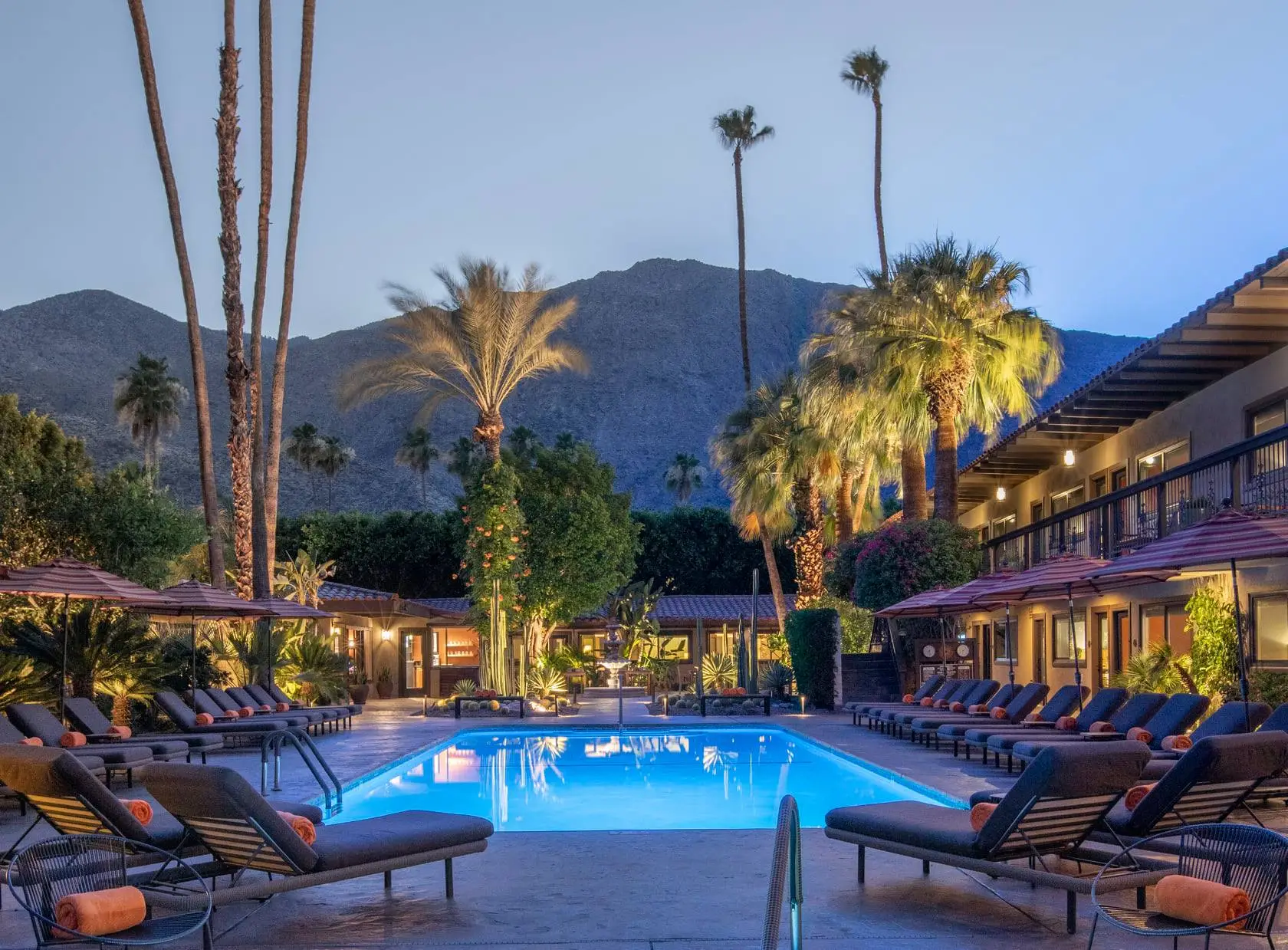 Santiago Resort's pool at dusk, with the water illuminated by a light inside