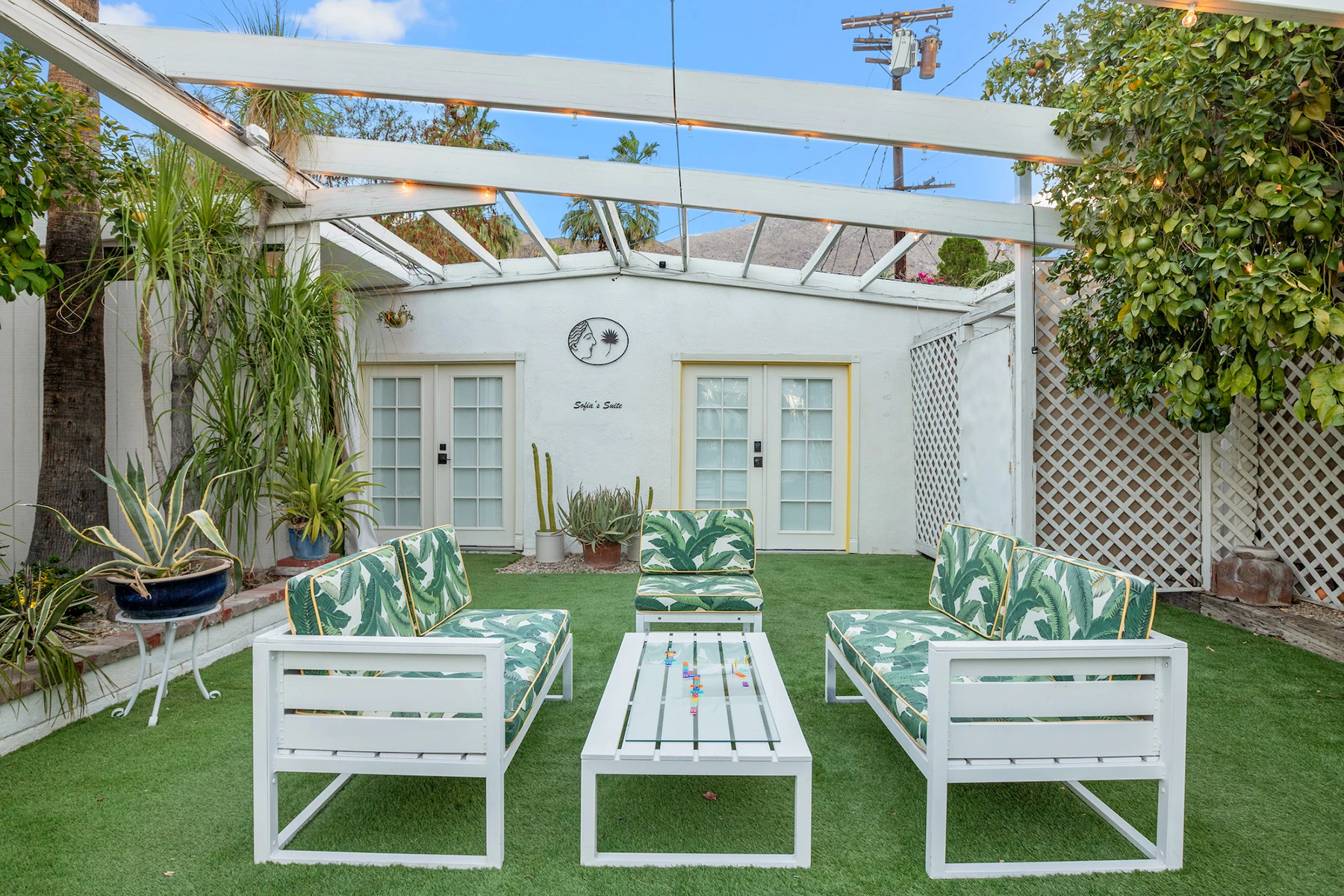 Green and white outdoor furniture on faux green grass at the Spirit of Sofia boutique hotel in Palm Springs, California