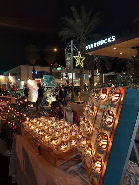 Candles light up the night at a vendor's stand at VillageFest