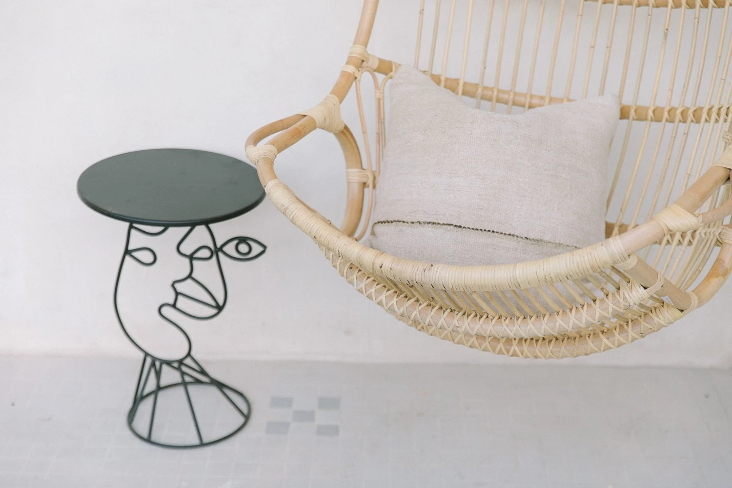 An unusually shaped table that looks like a person's face and a chair at the Yara Hotel in Palm Springs, California