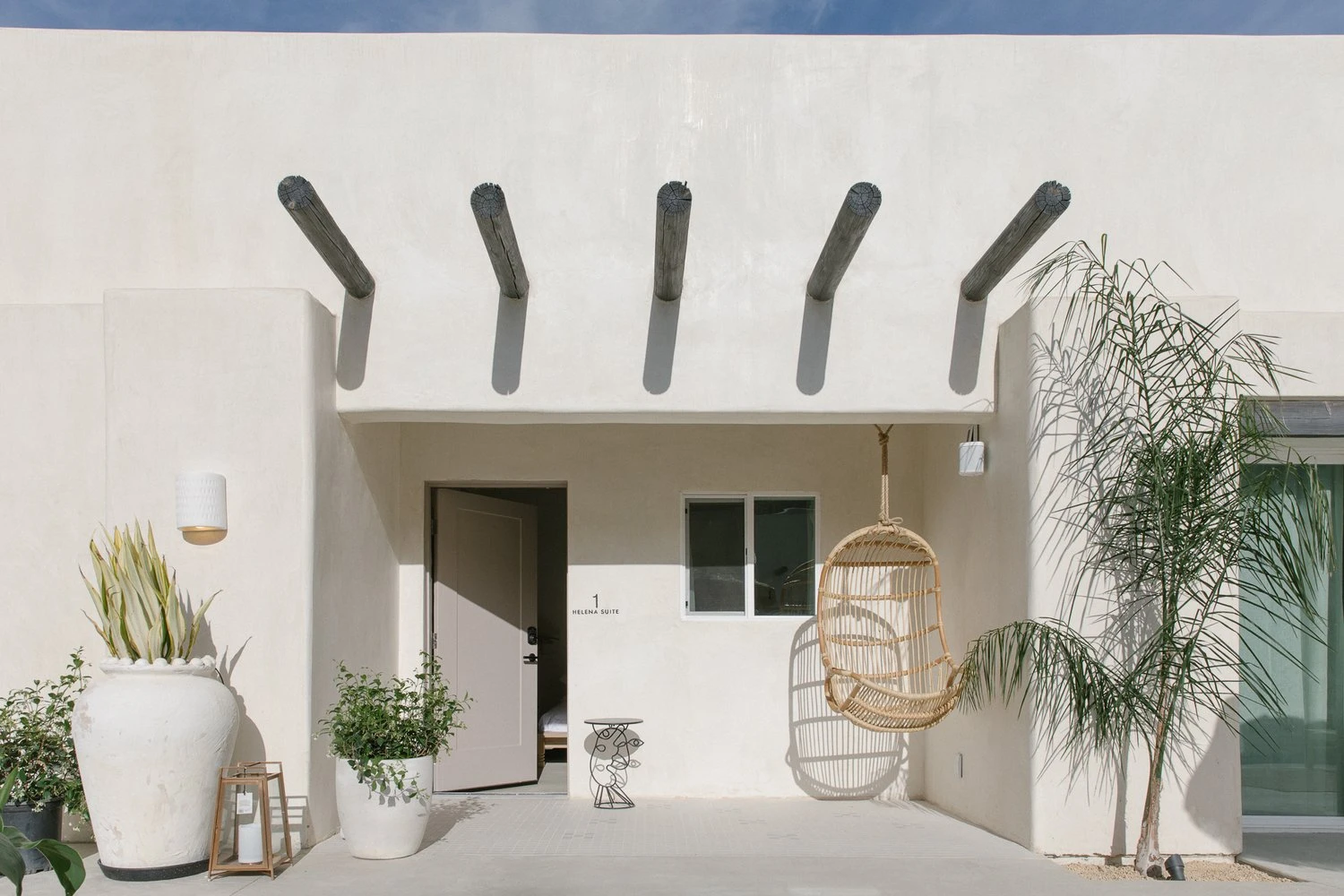 Wooden beams jut out a building's exterior at Yara Hotel in Palm Springs, California