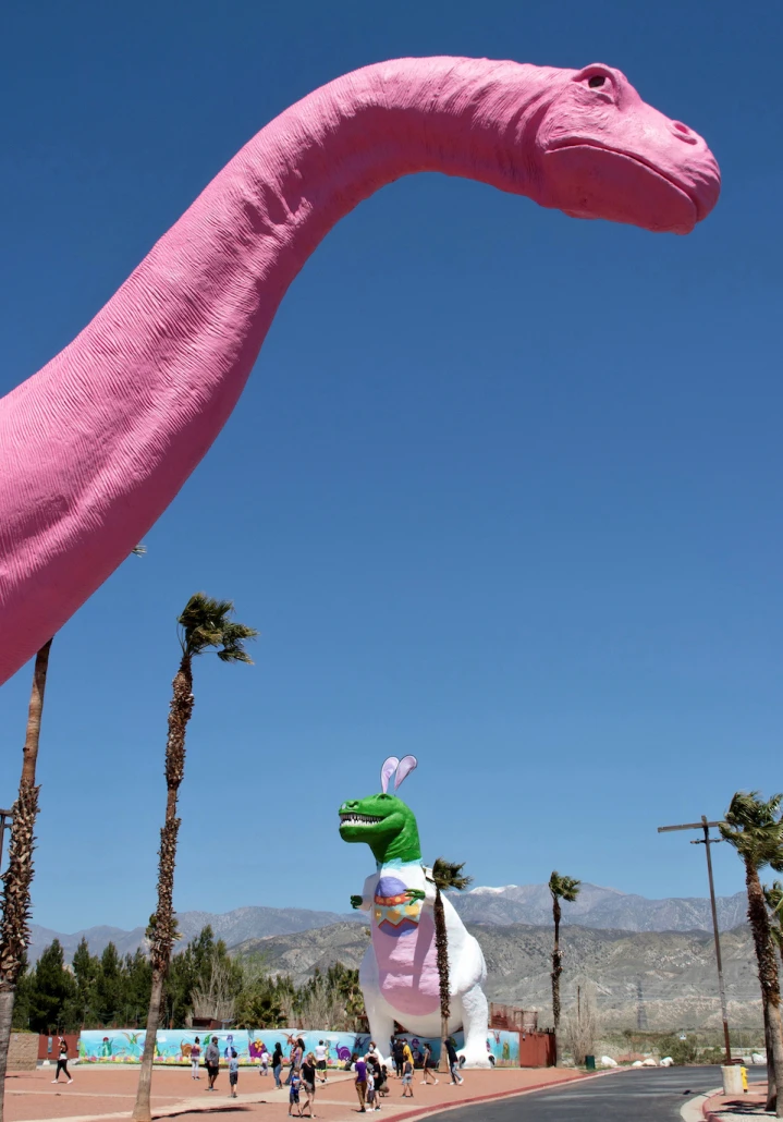 The giant pink dinosaur in Cabazon, California, with the T-Rex behind it