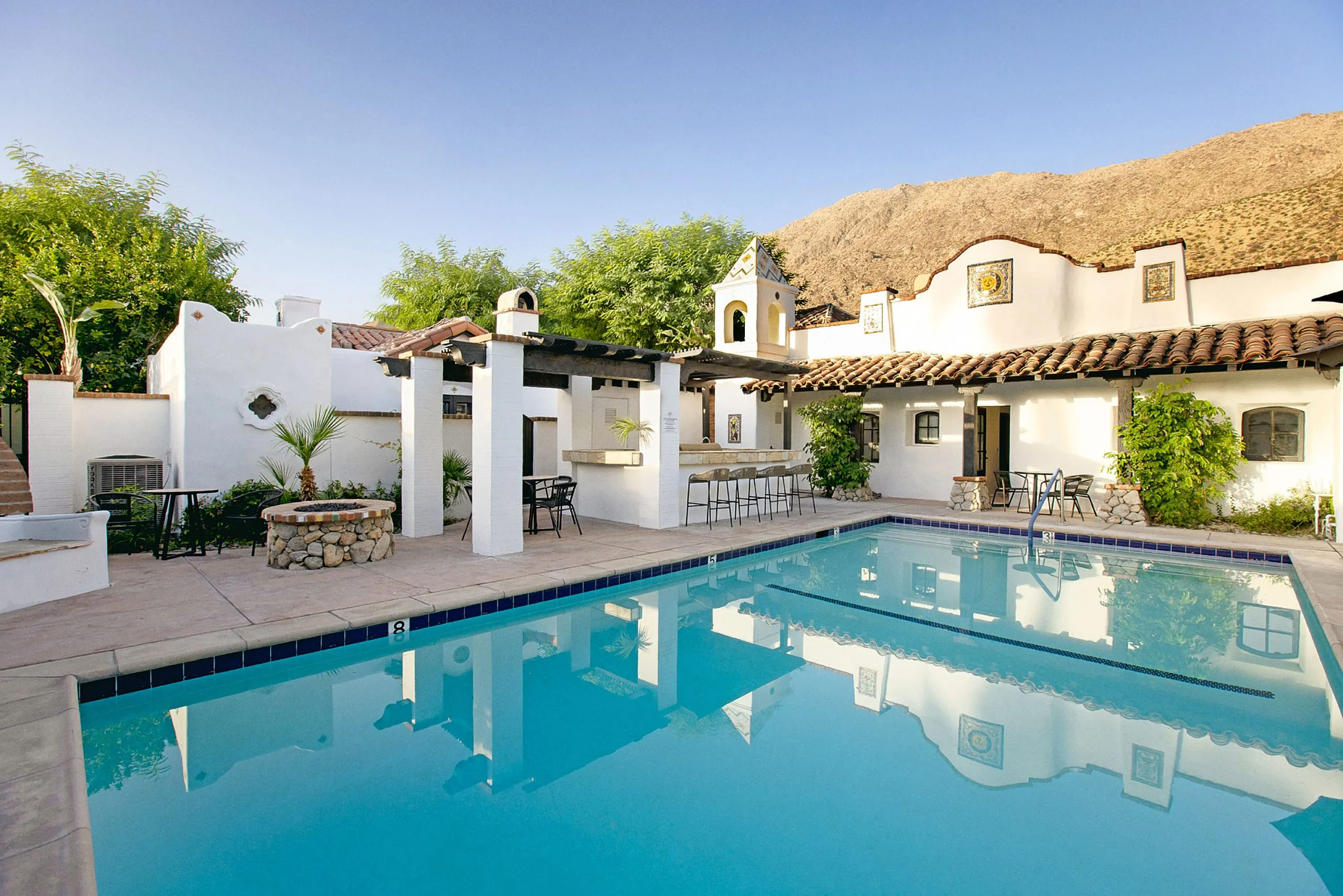 The San Jacinto Mountains behind the sparkling pool at The Lucille Palm Springs