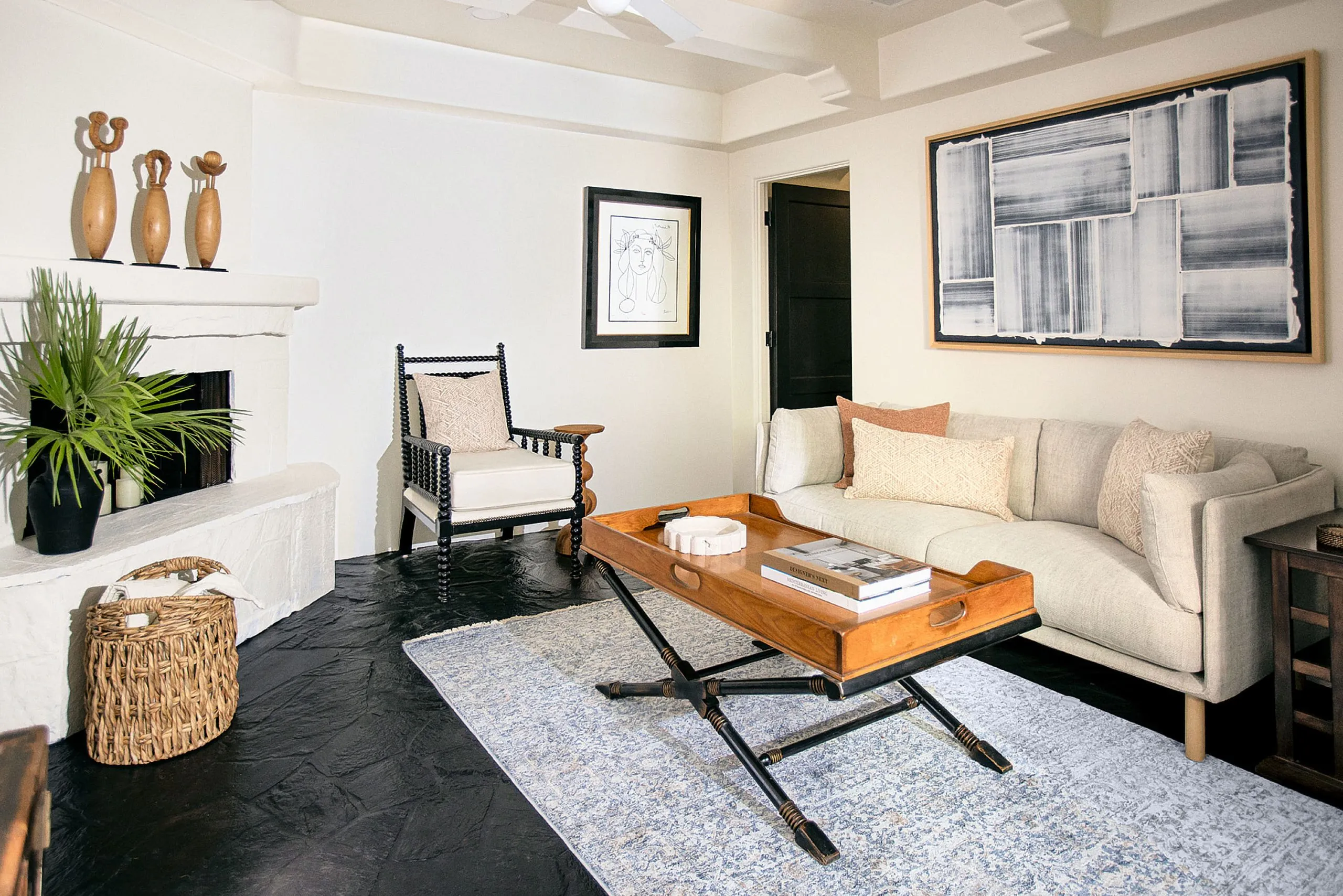 The inside of a room at The Lucille Palm Springs with a white couch and chair and wooden coffee table