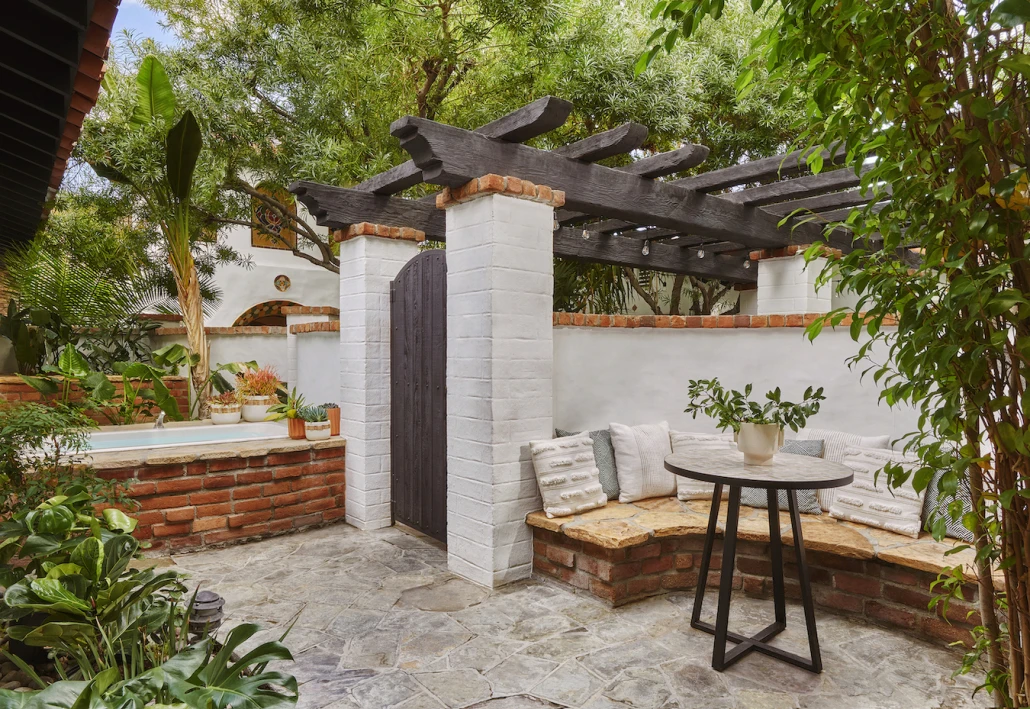 A private patio with outdoor tub surrounded by greenery at the Lucille boutique hotel in Palm Springs, California