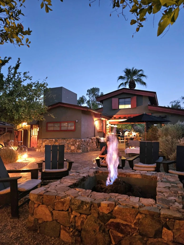 A flame dances in the night in a fire pit at Sparrows Lodge in Palm Springs, California