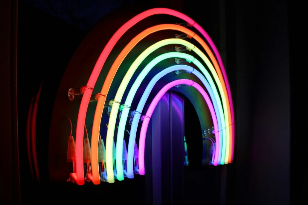 A neon LED rainbow on a black wall