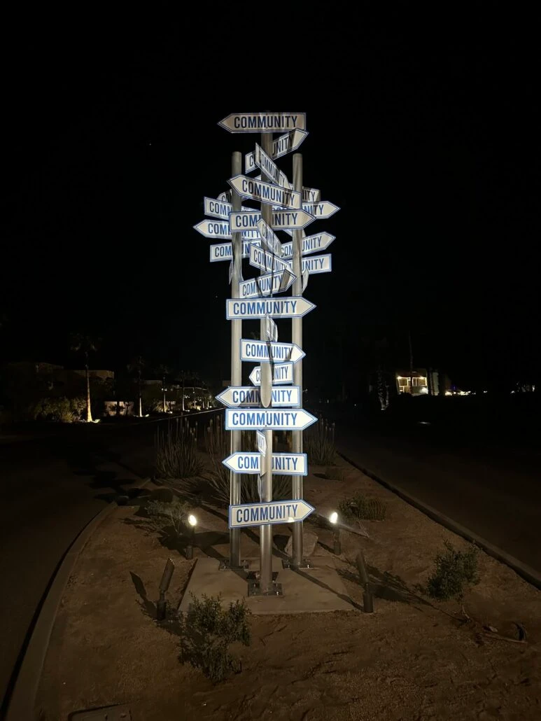 The Community pillar illuminated at night in Palm Springs