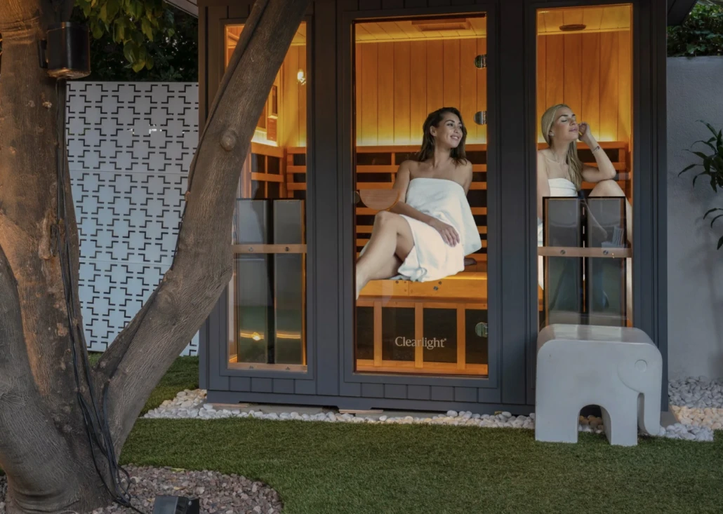 Two women sit in an infrared sauna at Dive Palm Springs