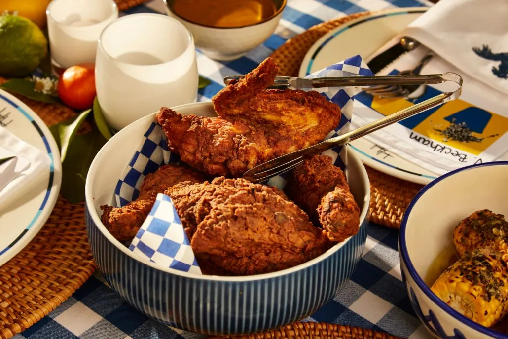 A pan filled with fried chicken on a table