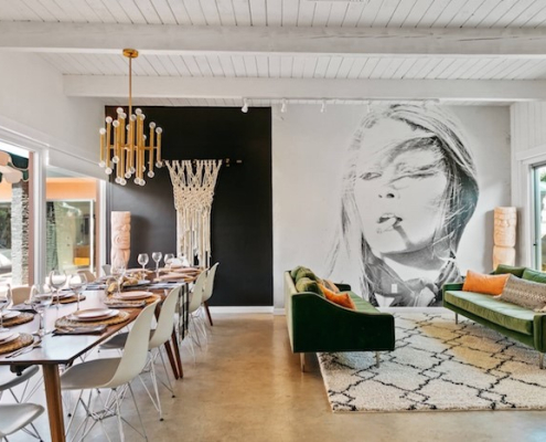 A large photo of a woman smoking covers a wall inside the living room at The Marley Palm Springs