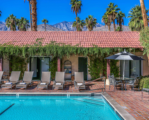 Greenery surrounds the large pool at La Maison Hotel in Palm Springs, California